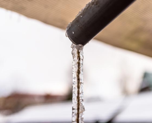 image of winter plumbing pipe with frozen water