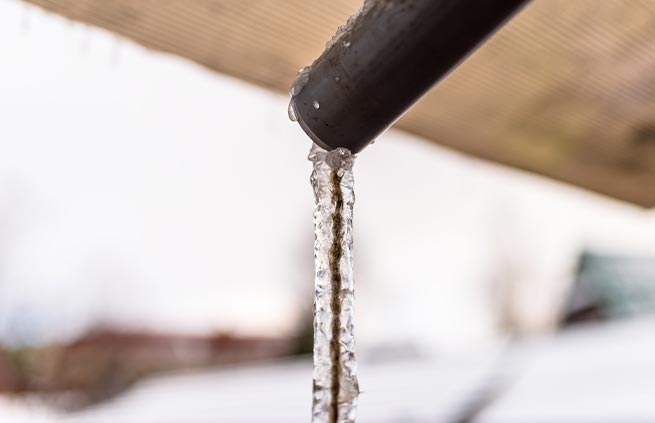 image of winter plumbing pipe with frozen water